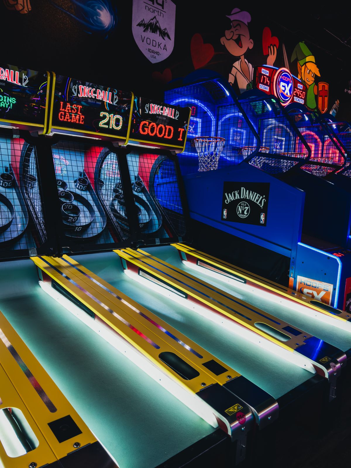 Vibrant Indoor Arcade with Neon Lights and Games · Free Stock Photo