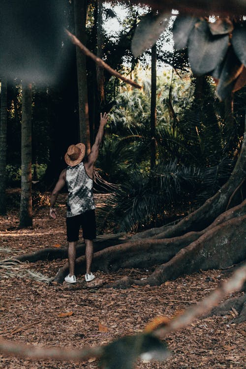 Selective Focus Photography of Man Standing Near A Big Tree