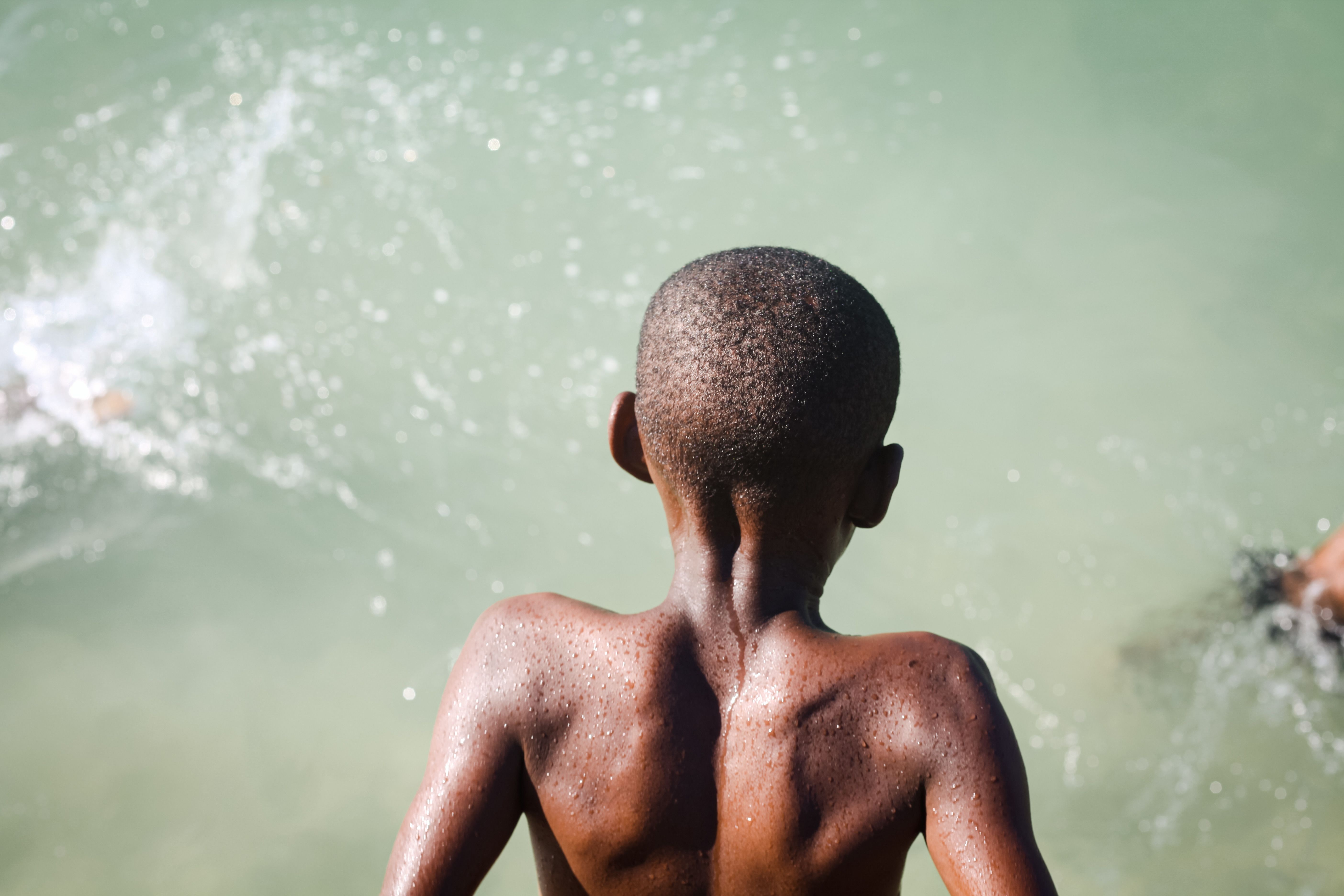 Young Boy Enjoying a Swim in Clear Waters · Free Stock Photo