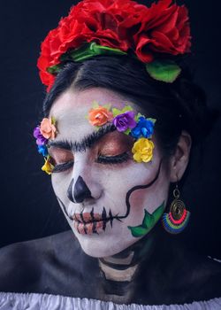 A colorful Day of the Dead makeup portrait with flowers, celebrating Mexican culture and tradition.