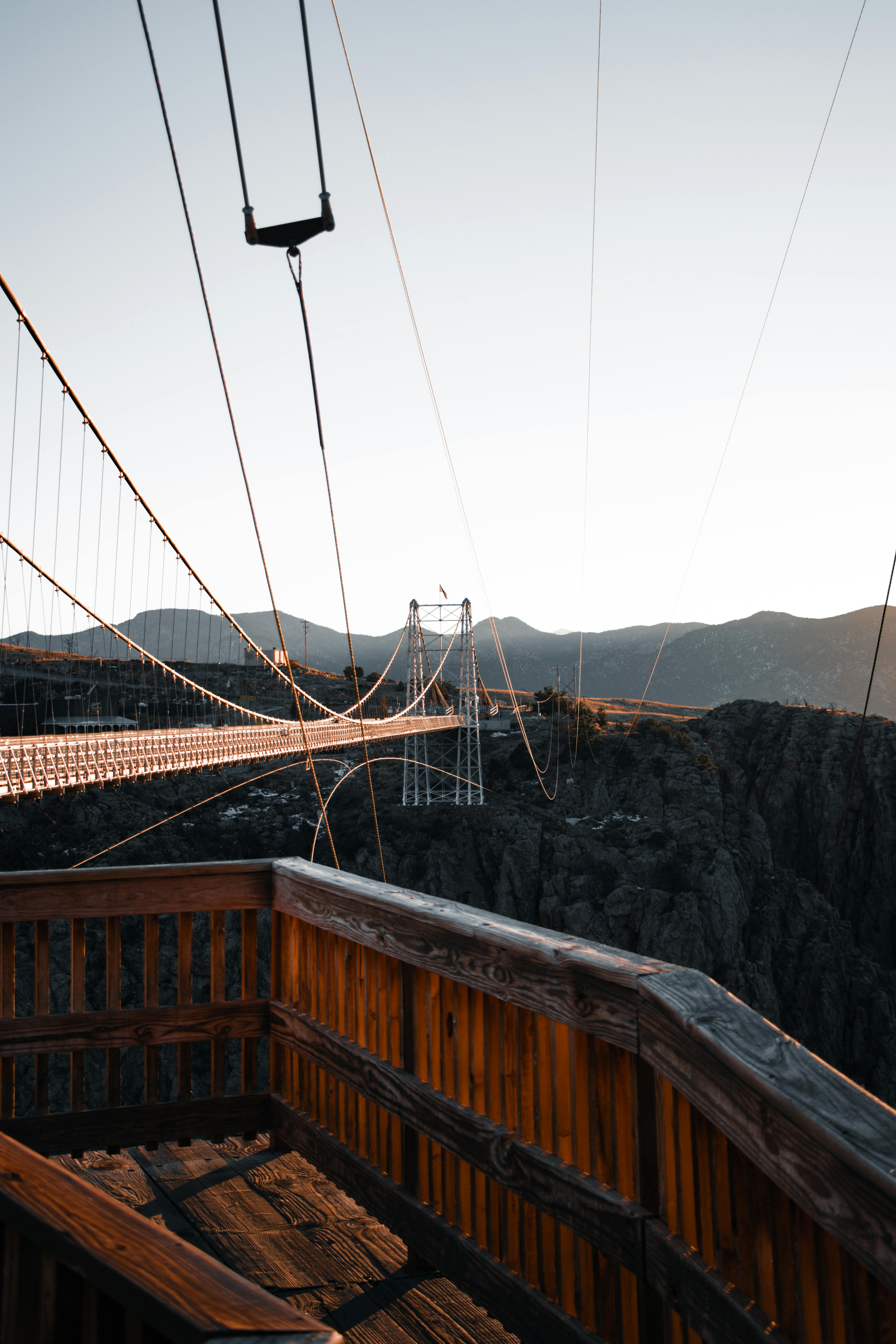 Stunning view of the Royal Gorge Bridge spanning a deep canyon at sunset in Colorado.