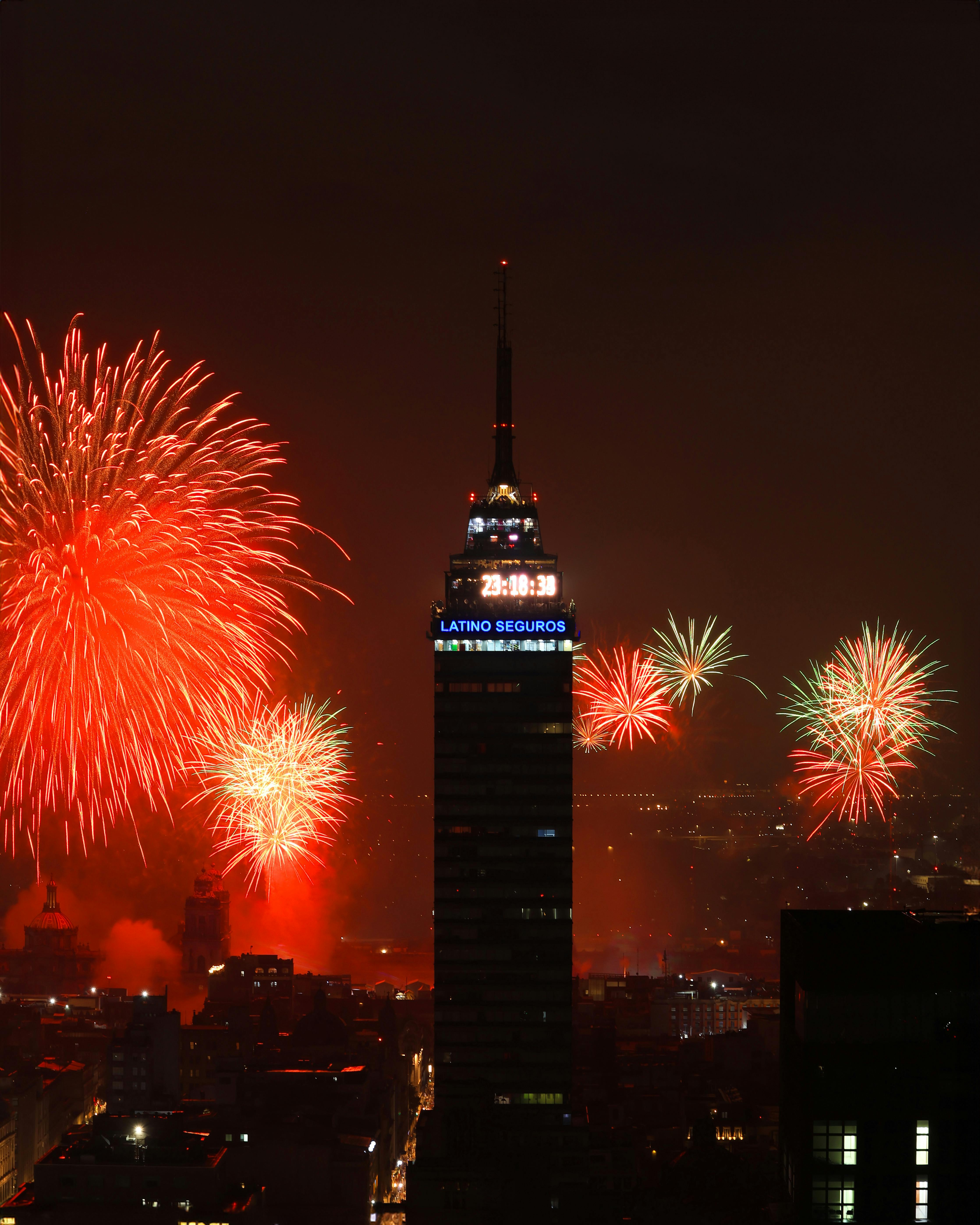 Spectacular fireworks display over Torre Latinoamericana in Mexico City at night.
