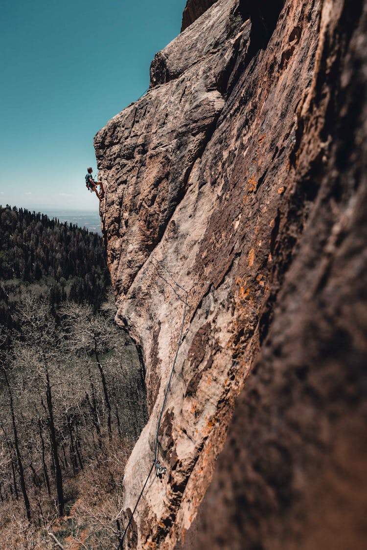 Photo Of Man Rock Climbing
