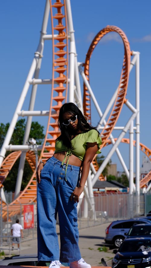 Free Photo Of Woman Standing Near Roller Coaster Stock Photo