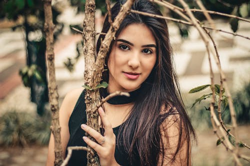 Photo Of Woman Holding Tree Branch