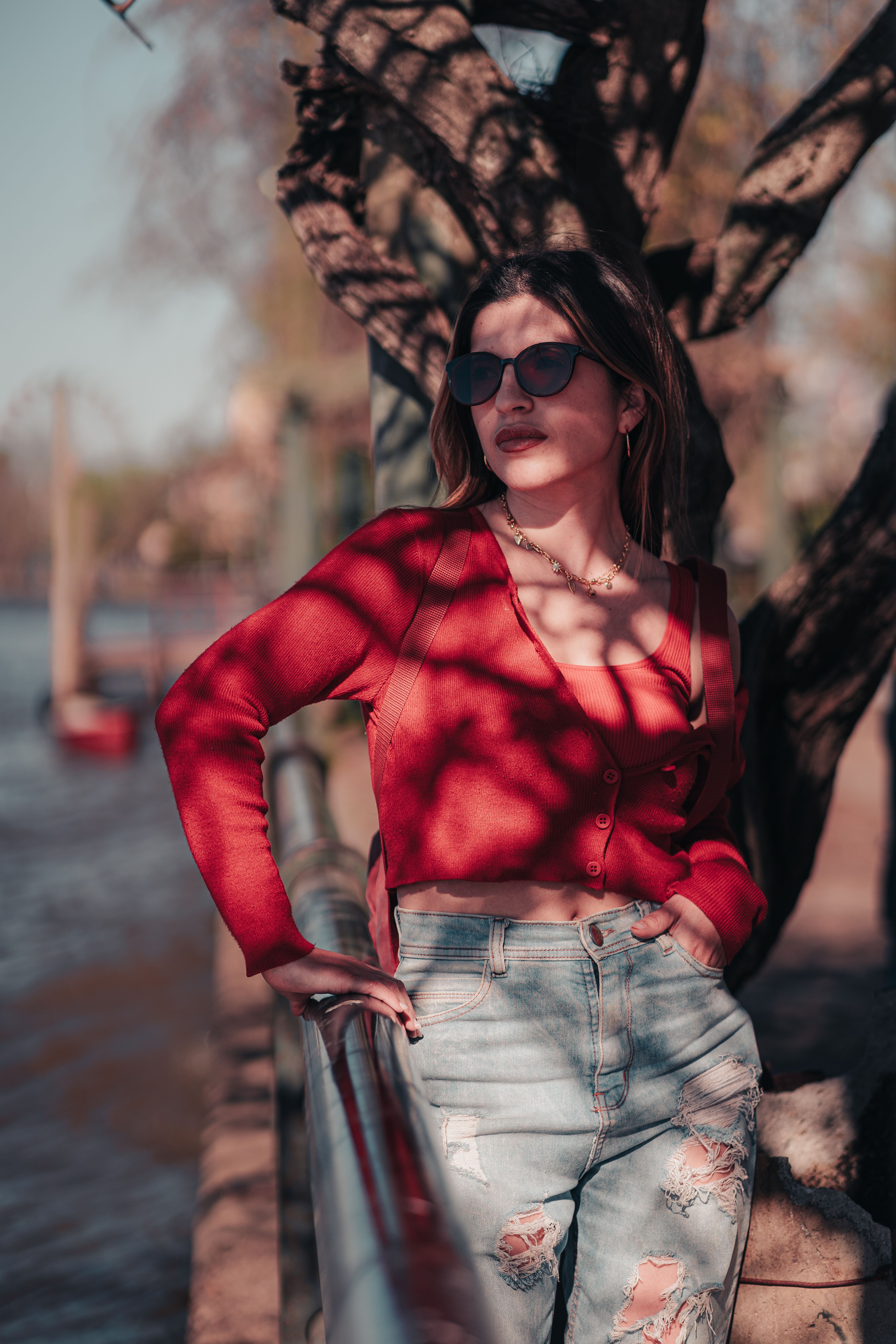 Stylish Woman Posing Outdoors in Sunglasses · Free Stock Photo