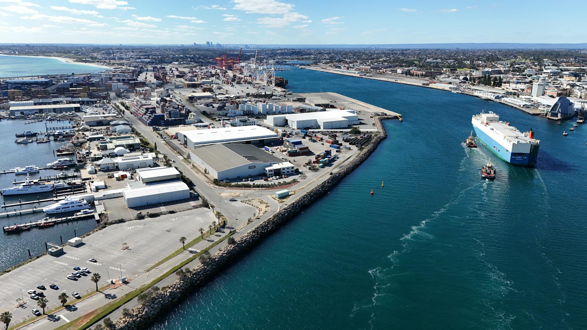 Aerial shot of Fremantle Port in Western Australia, showcasing container ships and industrial landscape.