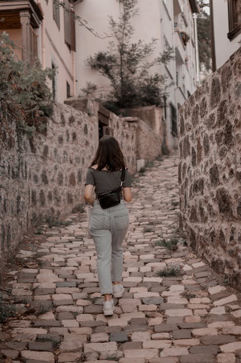 Photo Of Woman Walking On Pavement