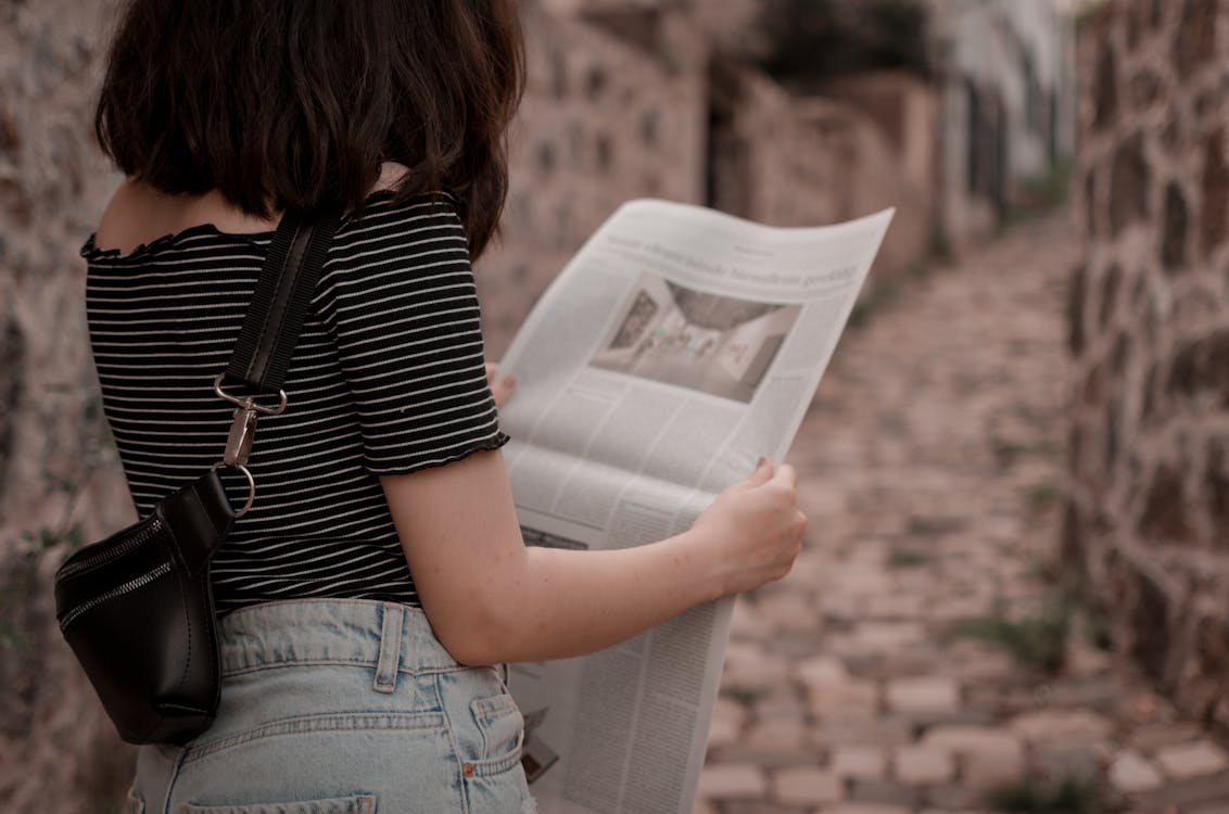 Photo Of Woman Reading Newspaper