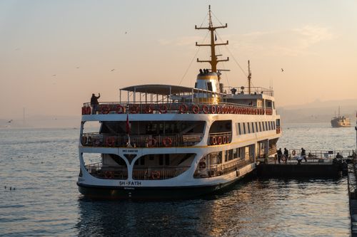 Free A serene view of a ferry crossing the Bosphorus in Istanbul, Türkiye at sunset. Stock Photo