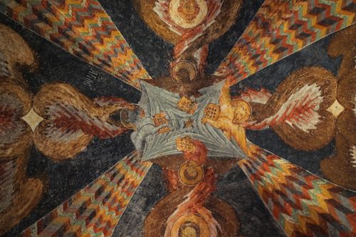 Free Detailed artwork of angels and vibrant patterns on a historic ceiling, captured indoors. Stock Photo