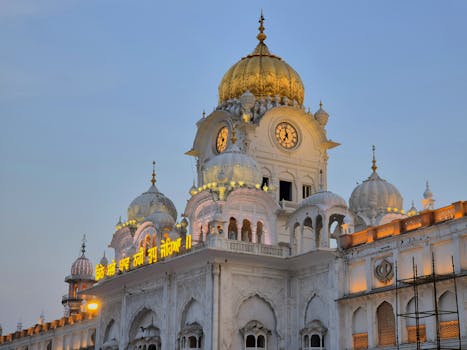 Stunning view of the Golden Temple Clock Tower at dusk with intricate architecture.