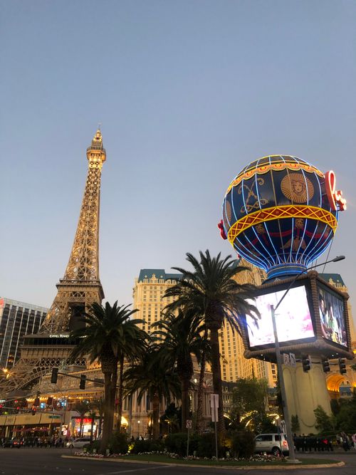 Free Eiffel Tower replica at Las Vegas Strip lit up at dusk, showcasing vibrant nightlife. Stock Photo
