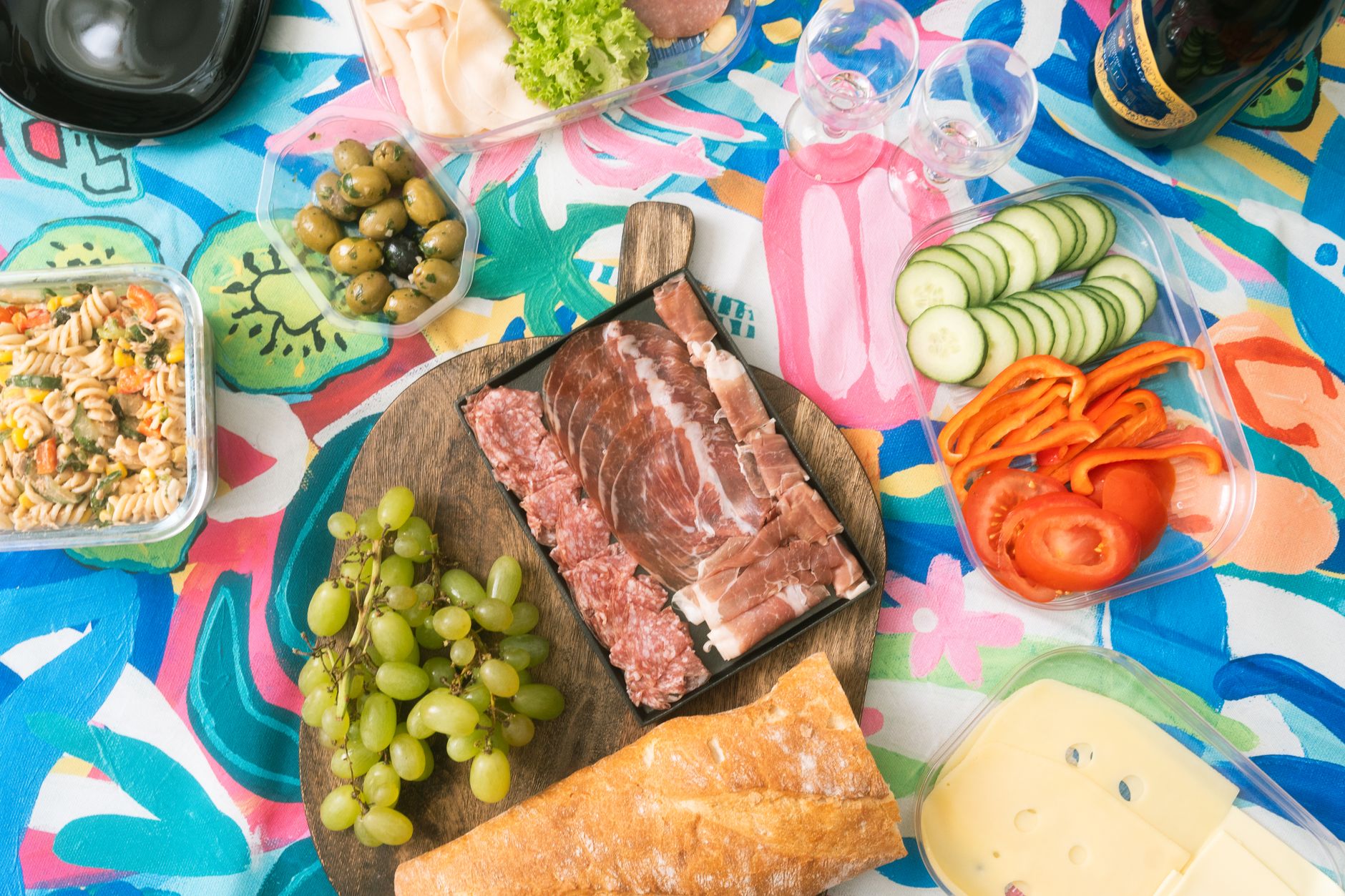 15 Creative Ways to Use Leftover Ham Deliciously Vibrant picnic display with meats, cheeses, and fresh produce on a colorful tablecloth.