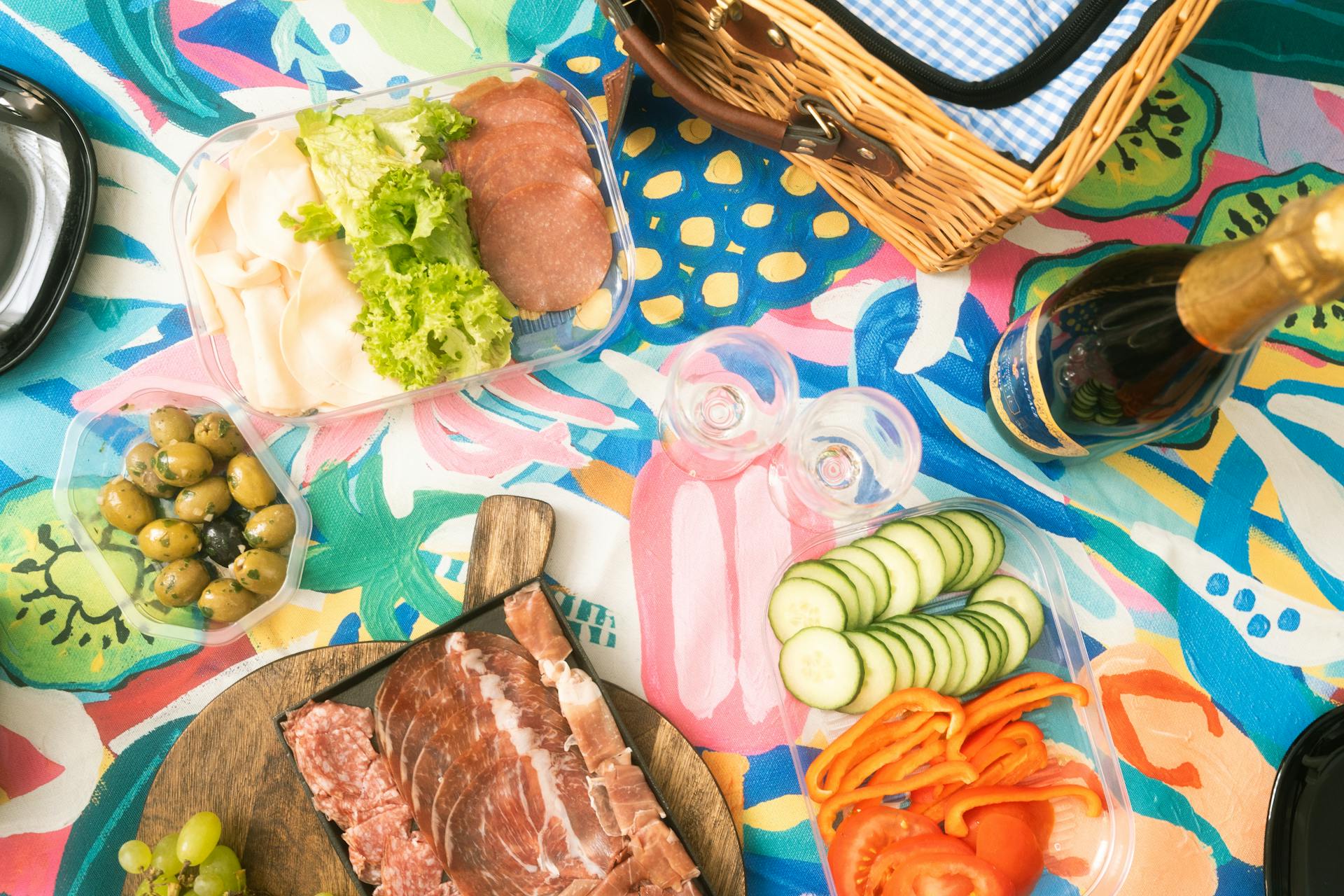 Vibrant Picnic Spread with Champagne and Meats