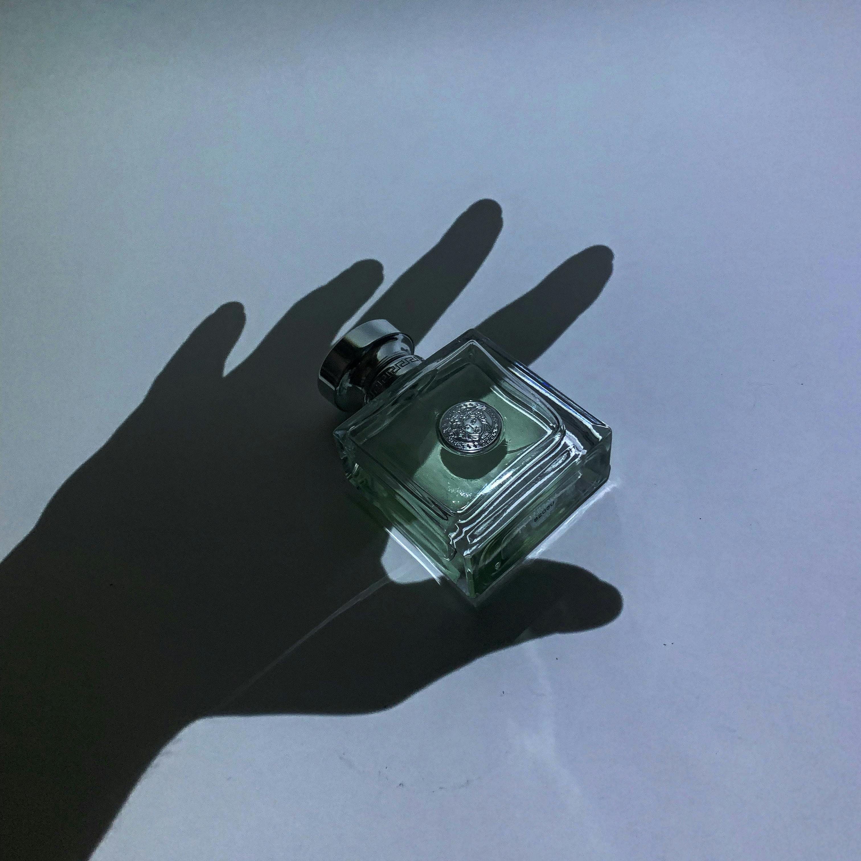Artistic Shadow of Perfume Bottle with Hand