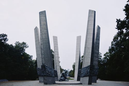 Free Monument commemorating the Warsaw Uprising surrounded by greenery in a peaceful park setting. Stock Photo