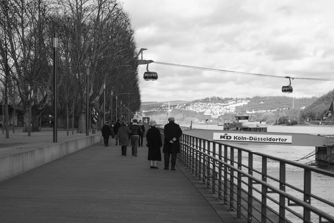 Grayscale Photo of Group of People Walking