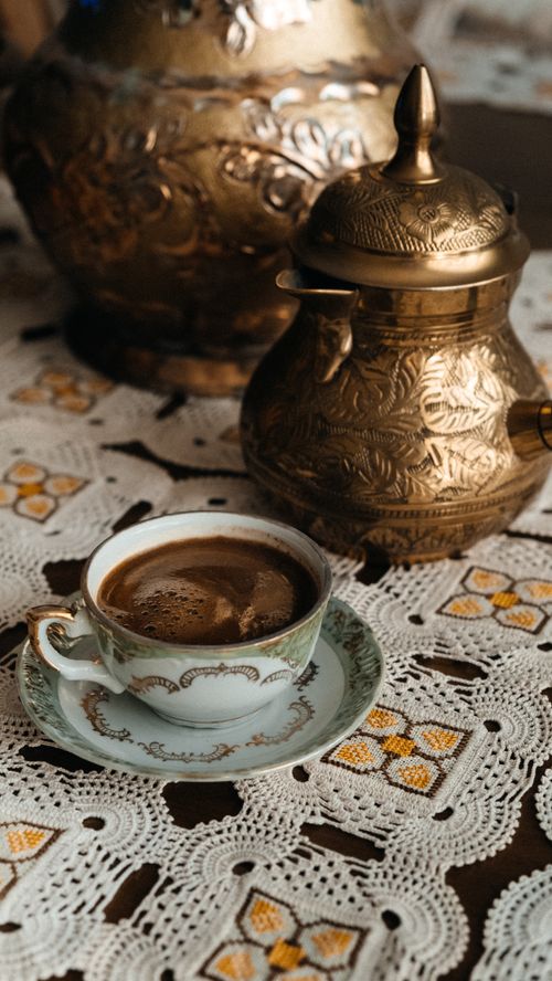 Free Ornate Turkish coffee set on a lace tablecloth, capturing a moment of rich tradition and aroma. Stock Photo