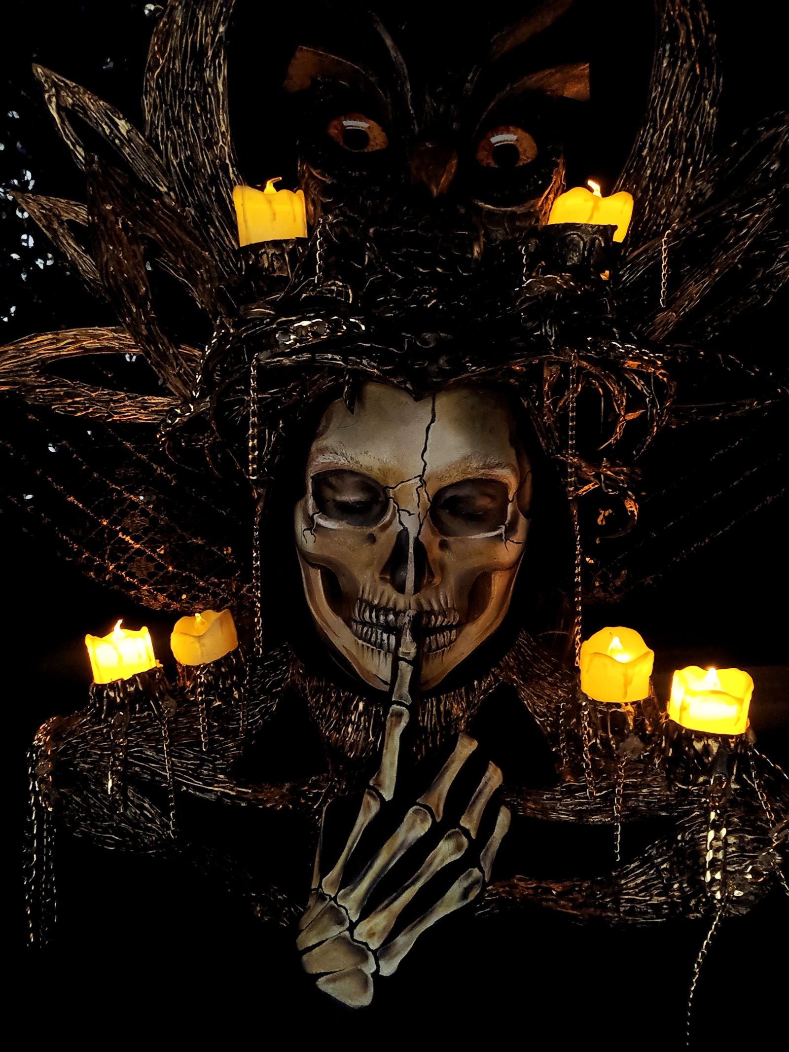 Dark Halloween skull surrounded by glowing candles
