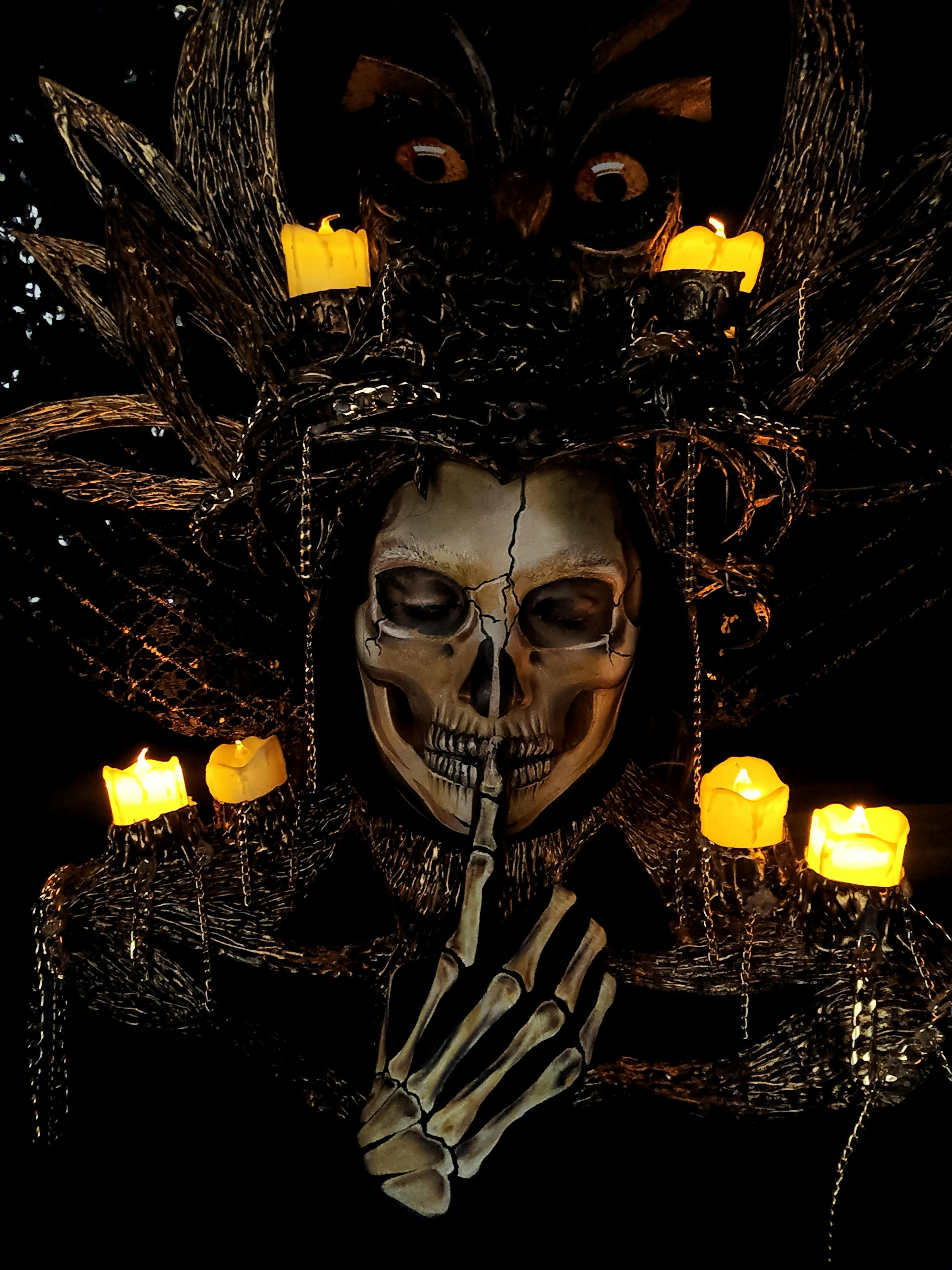Dark artistic depiction with candles and skull · Free Stock Photo