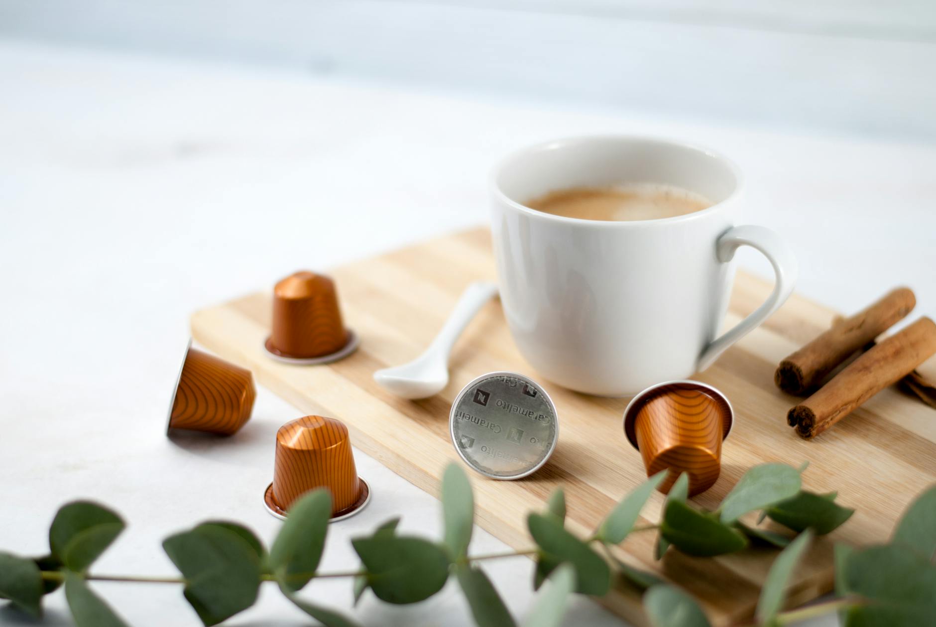 https://www.pexels.com/photo/warm-coffee-and-capsules-on-wooden-board-28482919/