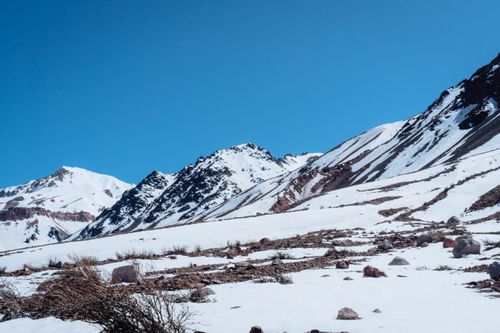 Free Expansive snowy landscape of Los Penitentes mountains under a clear blue sky. Stock Photo