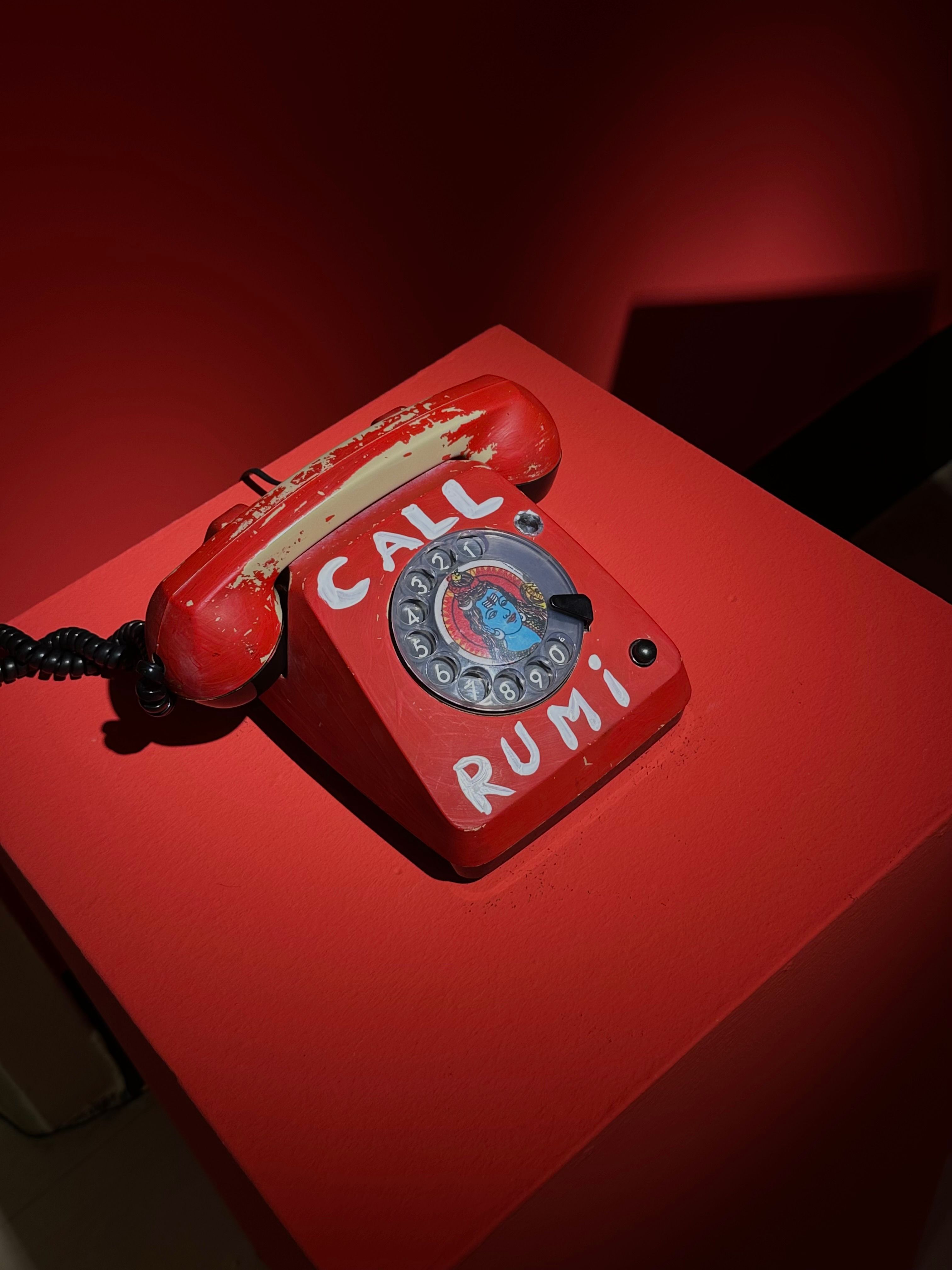 Vintage Red Rotary Phone with Call Rumi Text · Free Stock Photo