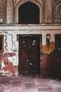 Closed Brown  Worn Down Wooden Door In A Building