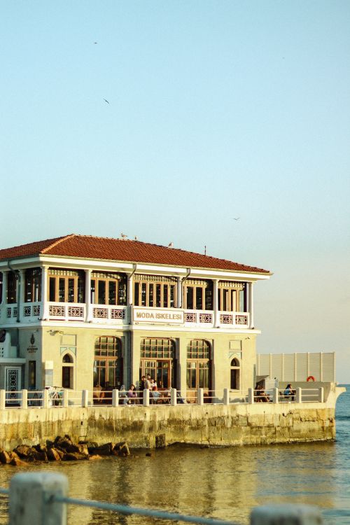 Free Scenic view of the iconic Moda Pier building beside the sea during a beautiful sunset. Stock Photo
