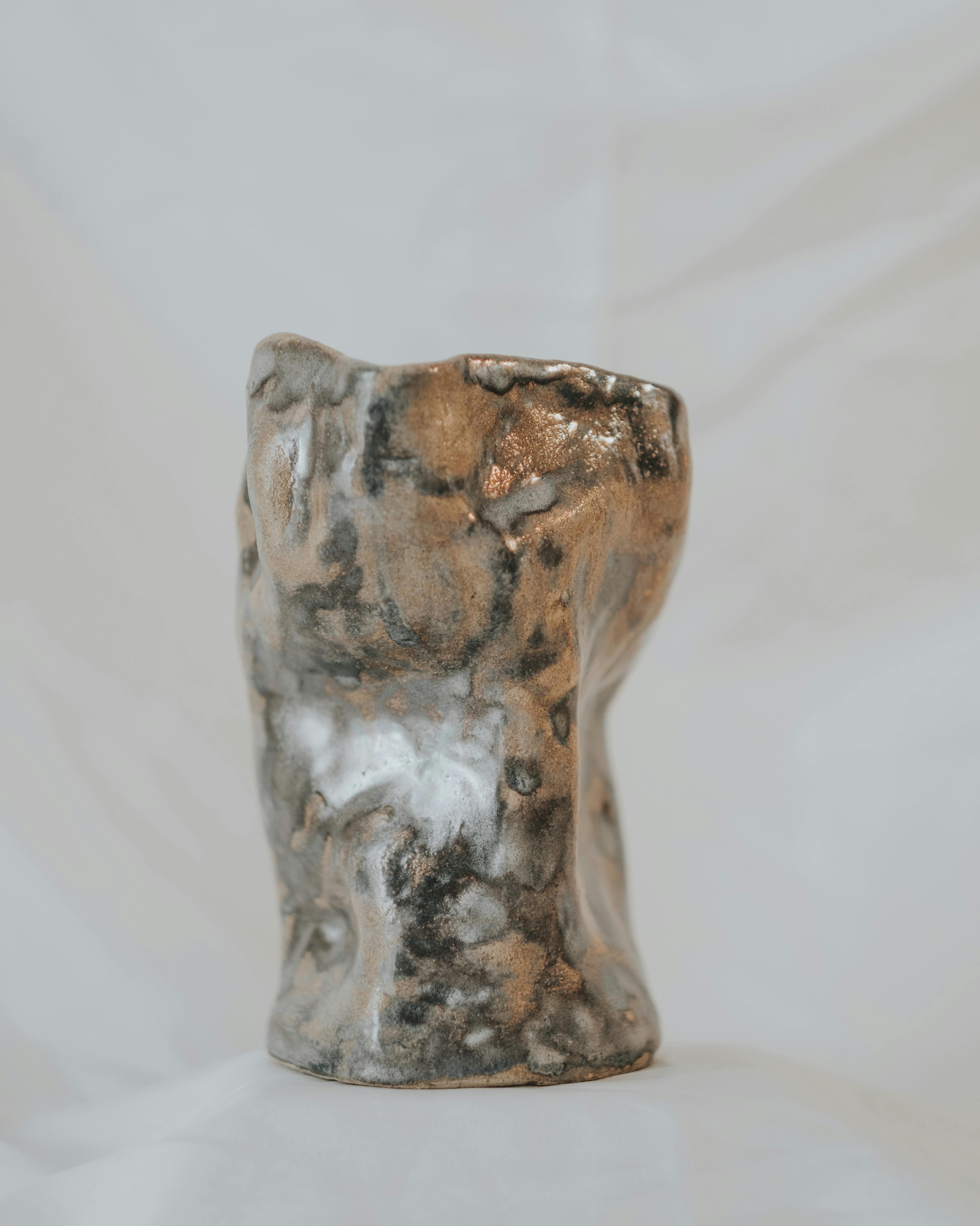 Artistic handcrafted ceramic sculpture with a rustic texture, perfect for decor.