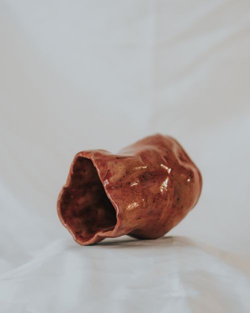 Free Artistic shot of a handcrafted ceramic piece with a unique organic shape and texture. Stock Photo