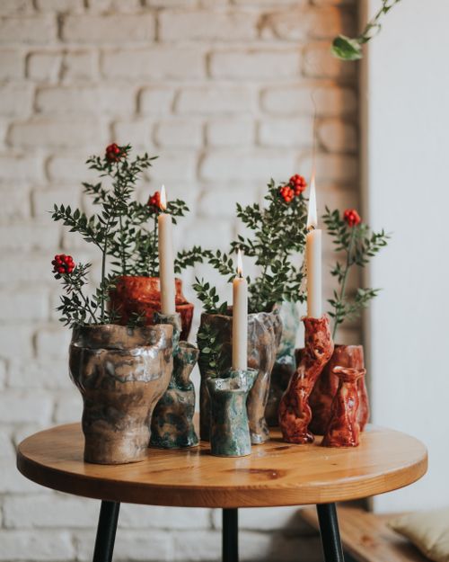 Free Elegant ceramic candle holders with greenery and berries on a wooden table, perfect for festive decor. Stock Photo
