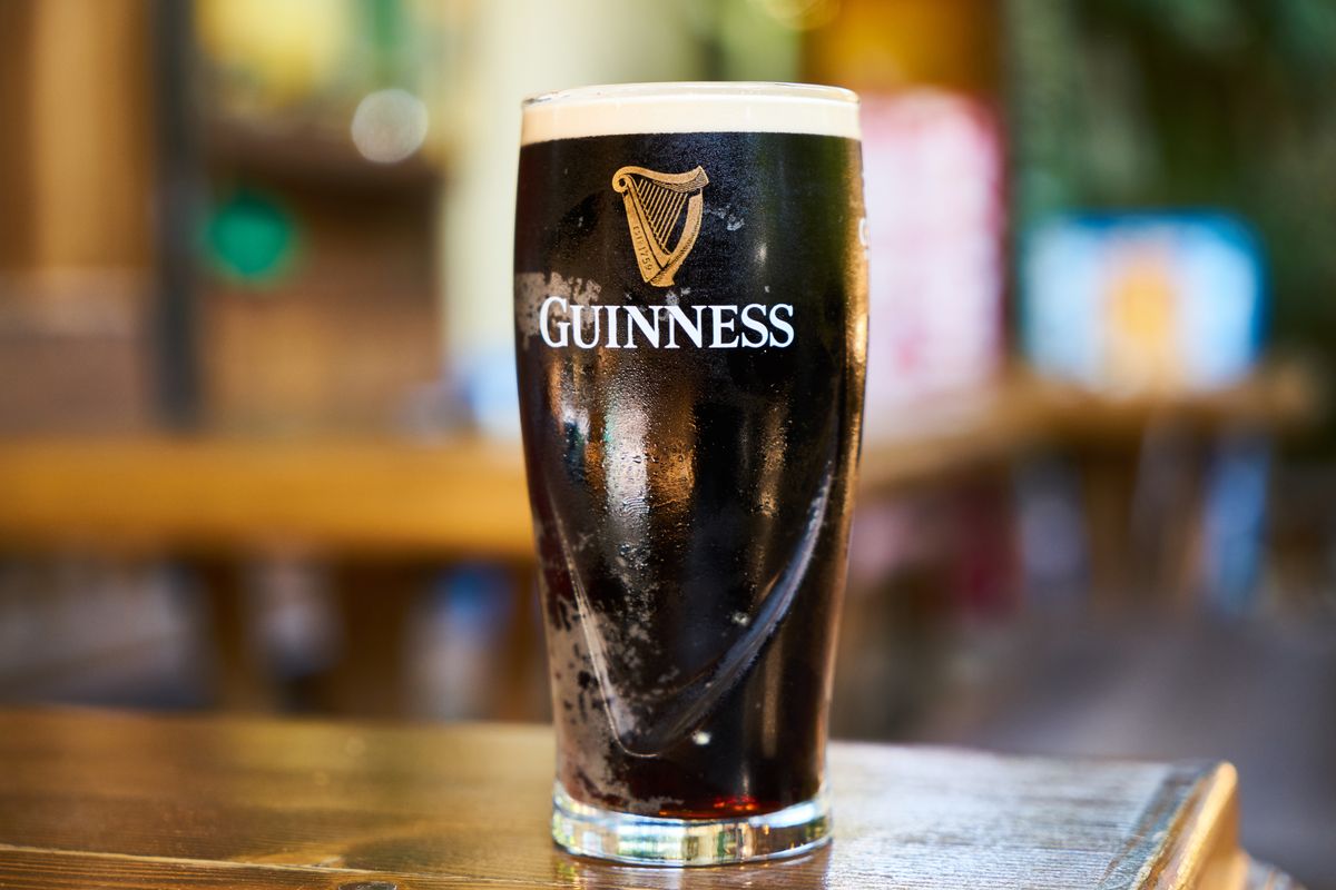 A pint of Guinness stout on a wooden table
