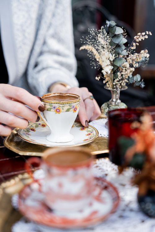 Free Capturing the elegance of Turkish coffee with vintage cups and floral decor in an Istanbul cafe. Stock Photo