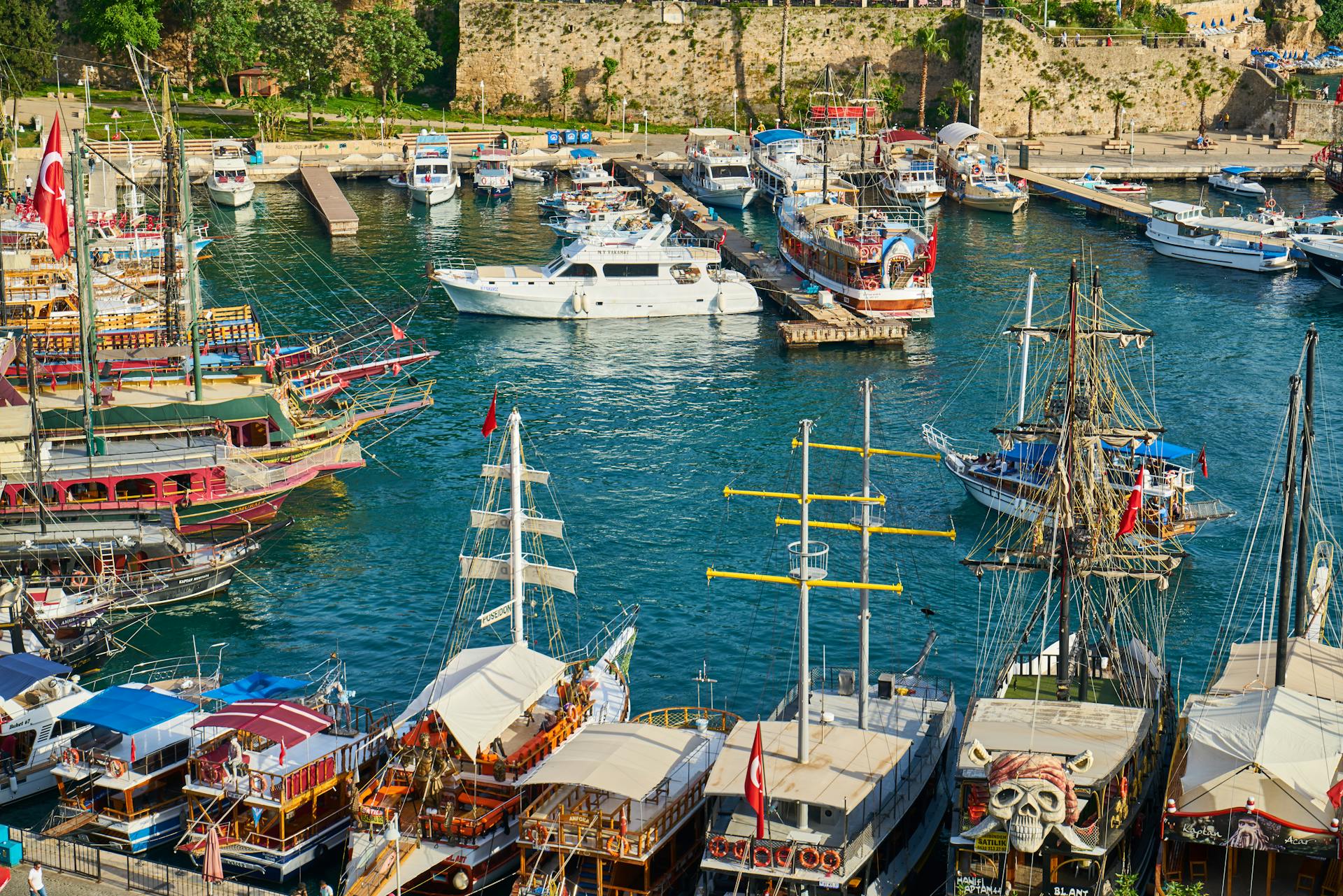 Colorful scene of boats docked at Antalya harbor, showcasing rich maritime life.