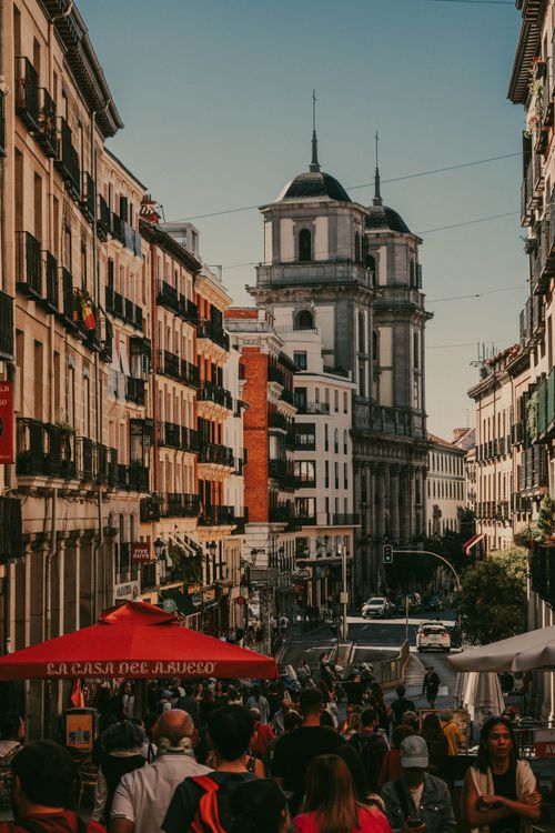 Free Bustling Madrid street with historical architecture and lively crowd. Stock Photo