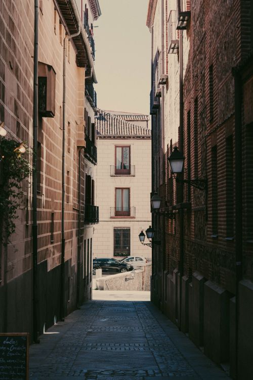Free Explore a picturesque narrow street in a historic European city, capturing architectural beauty. Stock Photo