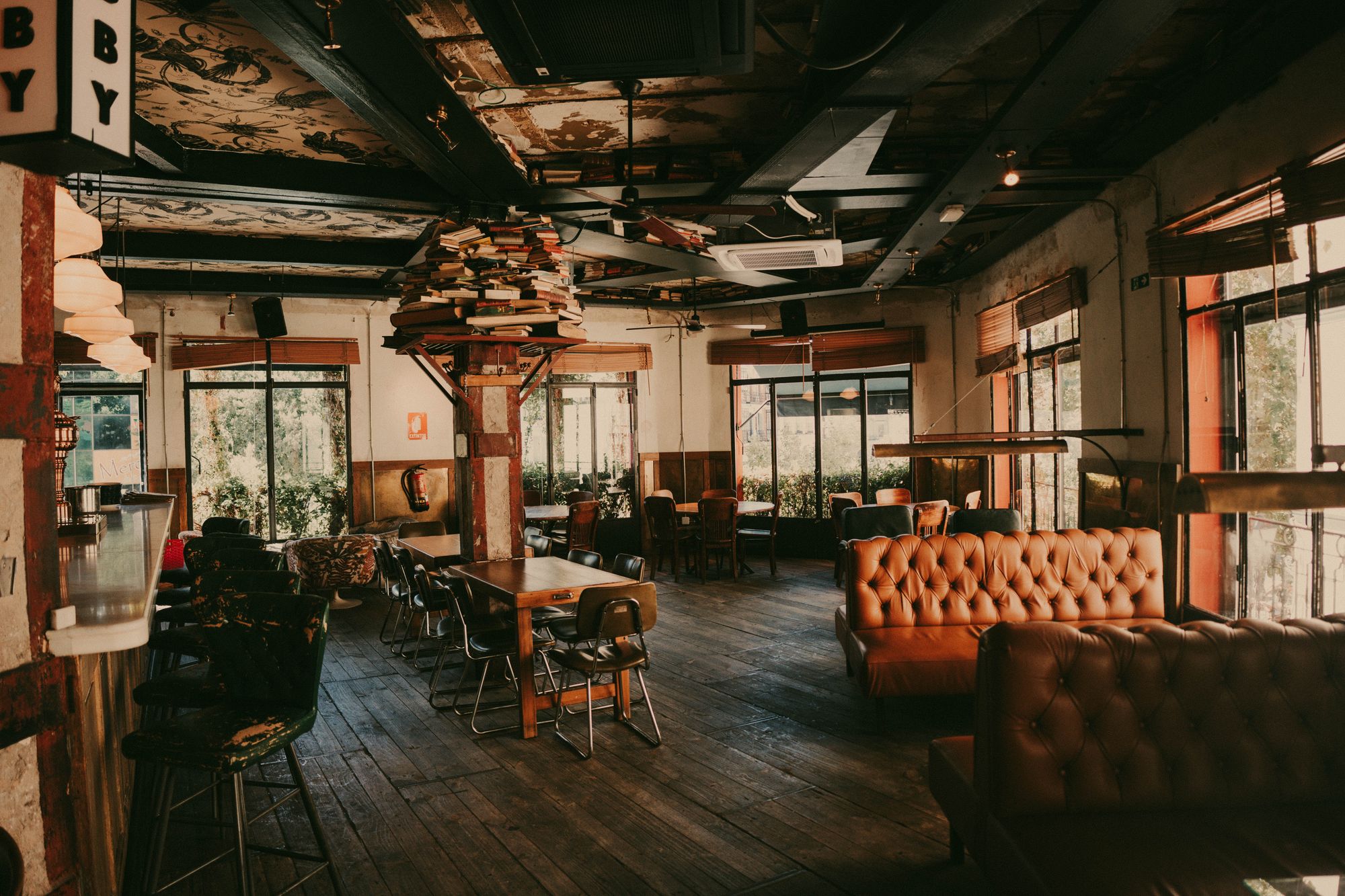 The warm, dimly lit interior of Forno Rosso with wooden tables and the glow of the brick oven