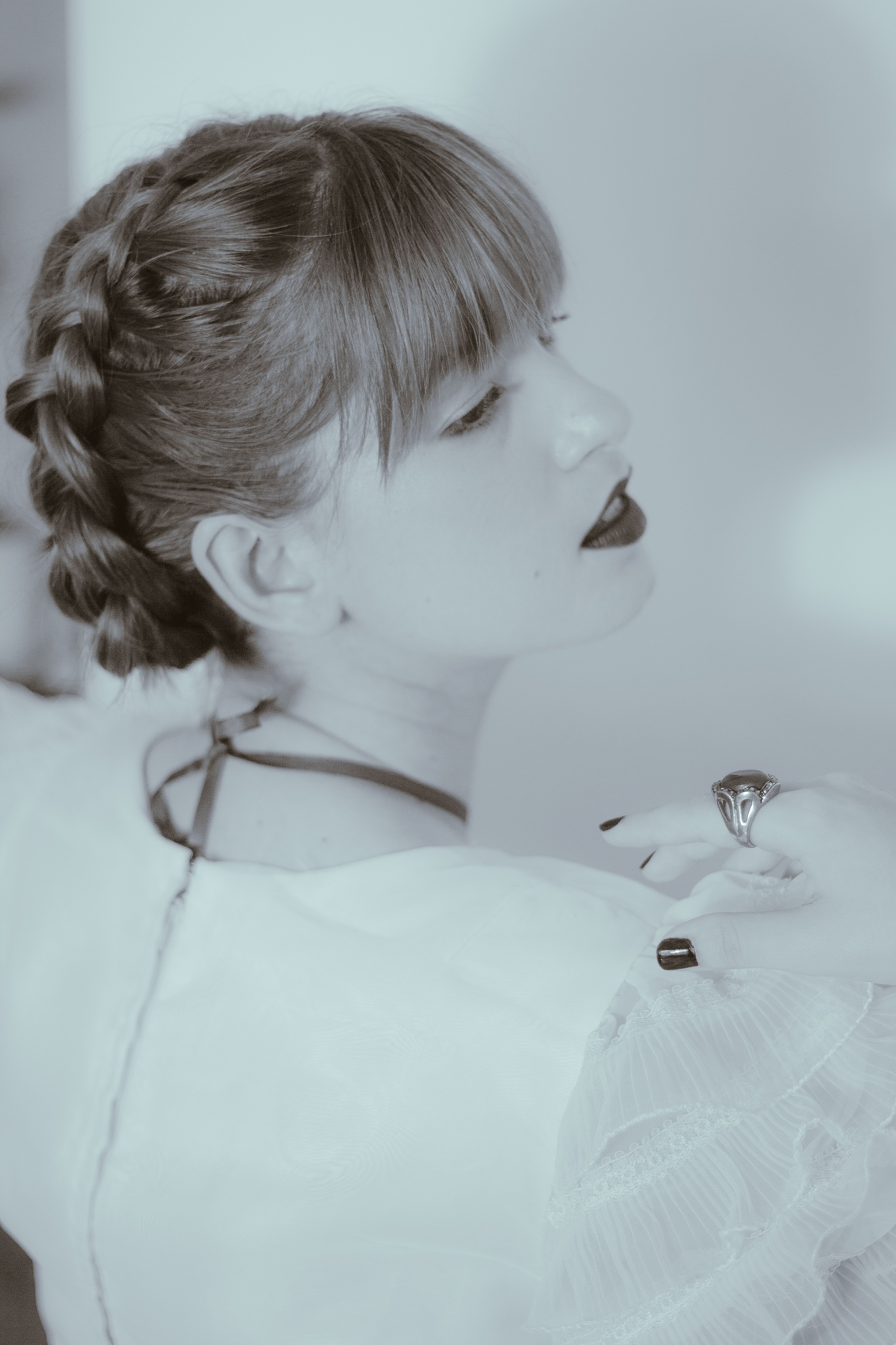 Artistic portrait of a woman with braided hair and vintage flair, evokes a timeless elegance.