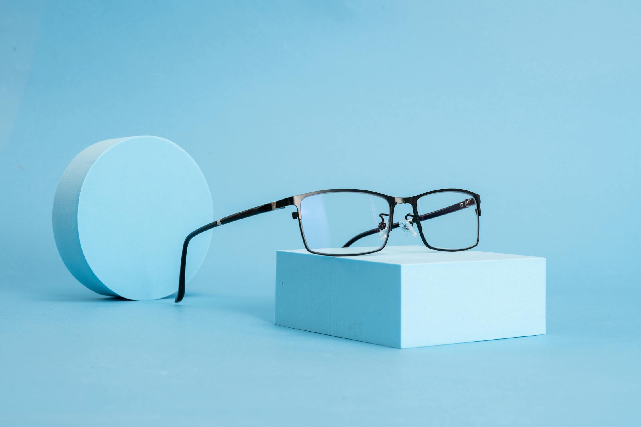Minimalist Eyeglasses on Blue Background ยท Free Stock Photo