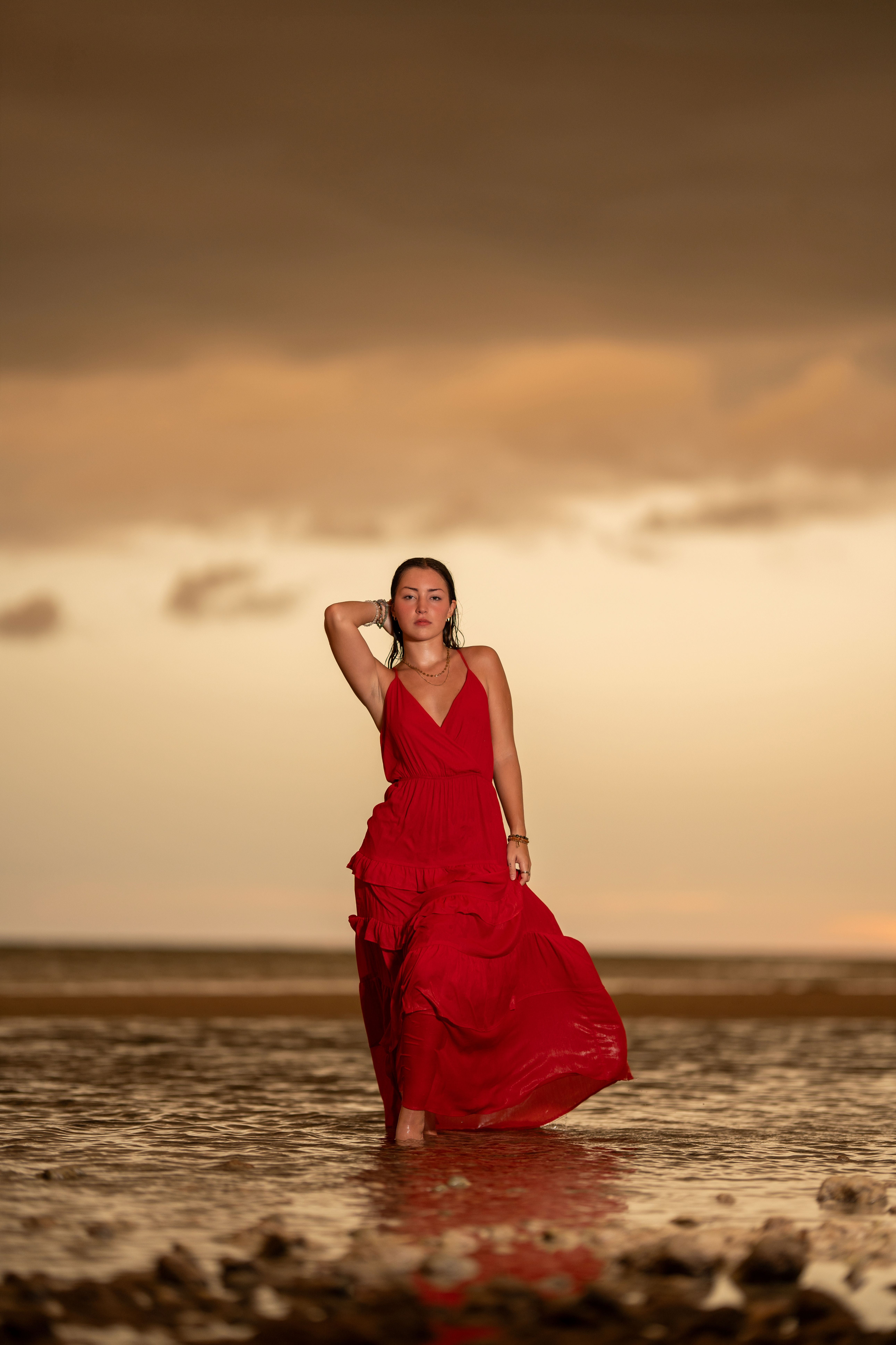 Woman in Red Dress Walking on Beach at Sunset  Free Stock Photo