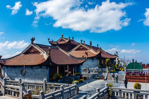 A stunning display of traditional Vietnamese temple architecture set against a vivid blue sky.