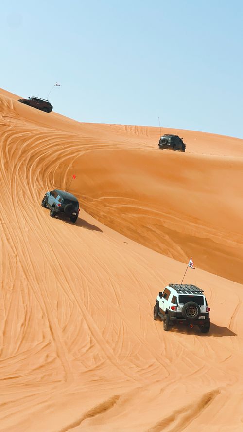 Free Exciting off-road adventure with SUVs traversing the sand dunes in Sharjah desert. Stock Photo