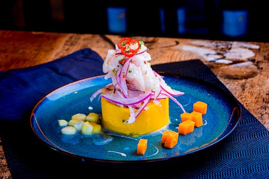 Vibrant Peruvian ceviche with sweet potato, corn, and chili on a blue plate.