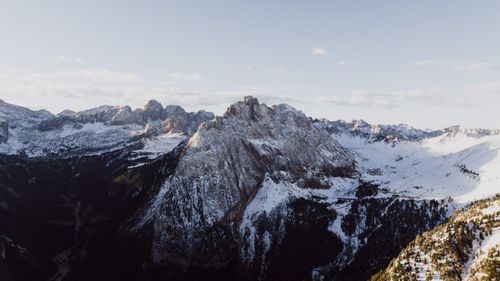 Free Aerial view of the majestic snow-covered Dolomites mountains during winter in Italy. Stock Photo