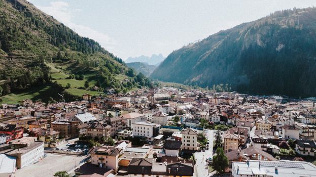 A picturesque aerial view of the village of Predazzo, nestled in the Italian Alps.