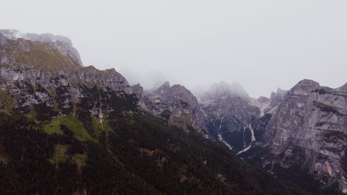 Free Captured view of the majestic Dolomites in Molveno, Italy, with clouds kissing the peaks. Stock Photo