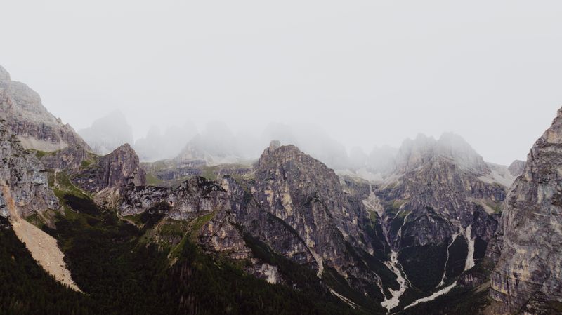 Vedere ceățoasă a Dolomiților cu drumuri montane