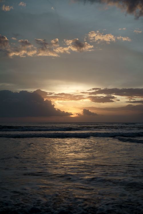 Free Beautiful sunset at Kuta Beach, Bali, with golden skies and gentle waves. Stock Photo